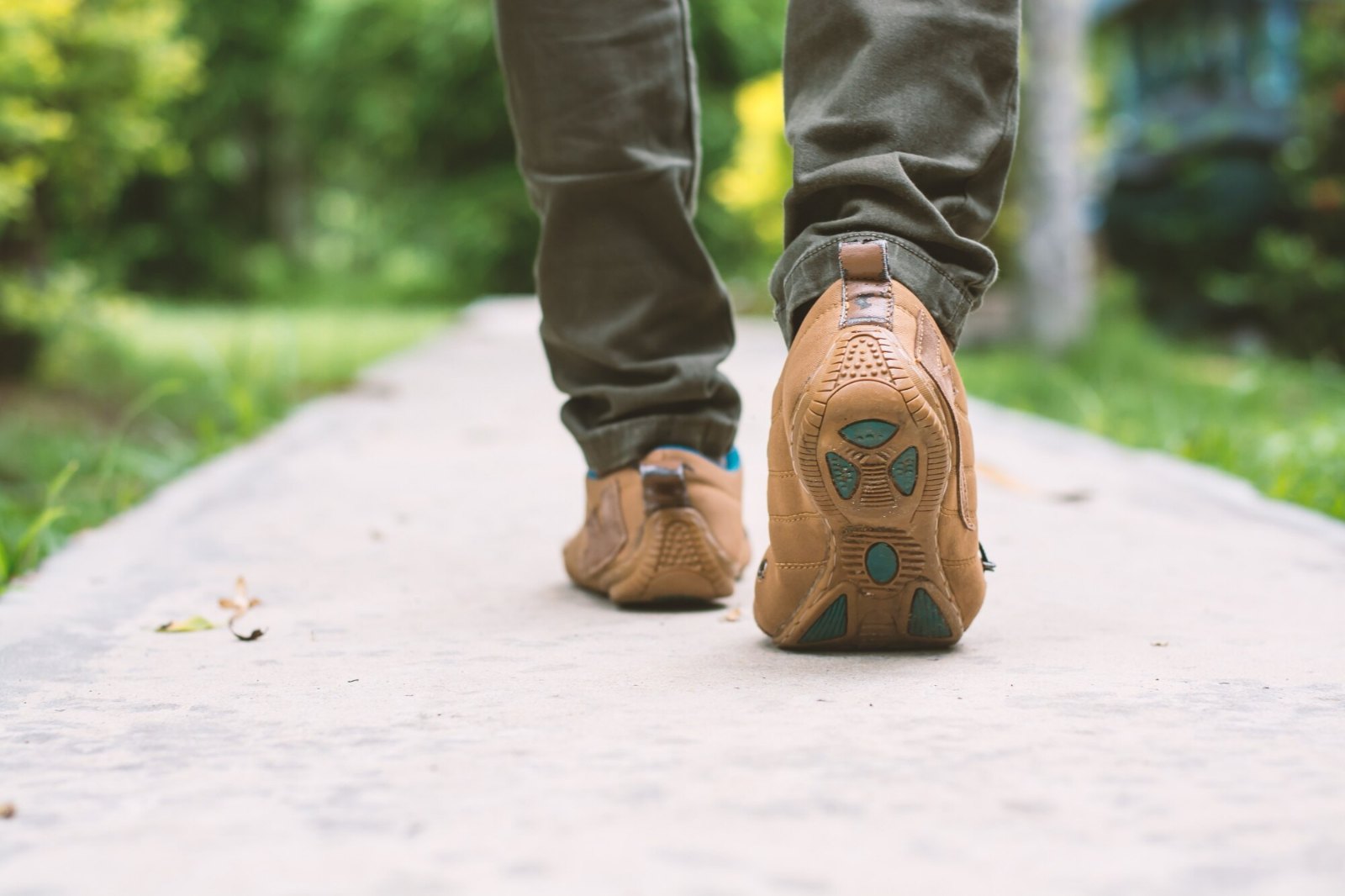 Marche quotidienne sur une allée de parc, vue des pieds en chaussures de ville